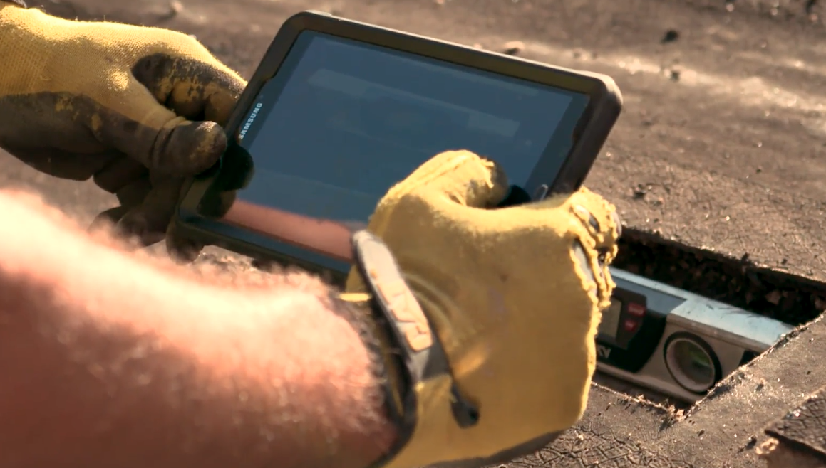 Simon Roofing technician uses a tablet to input roof assessment information